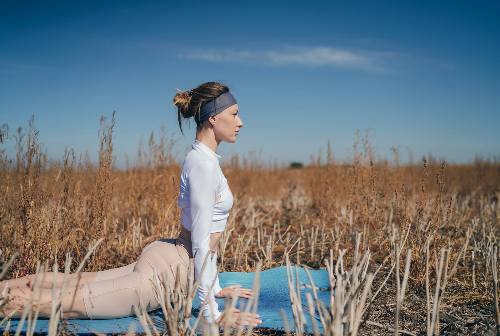 woman in white long sleeve shirt practicing yoga meditation