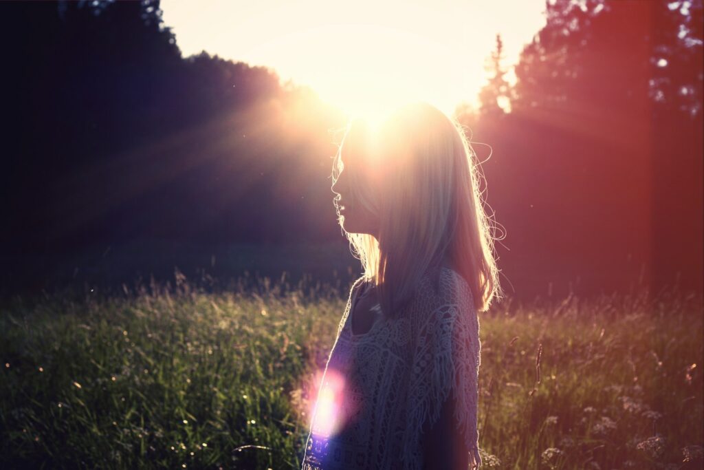 photo of woman on green grass field  - holistic lifestyle