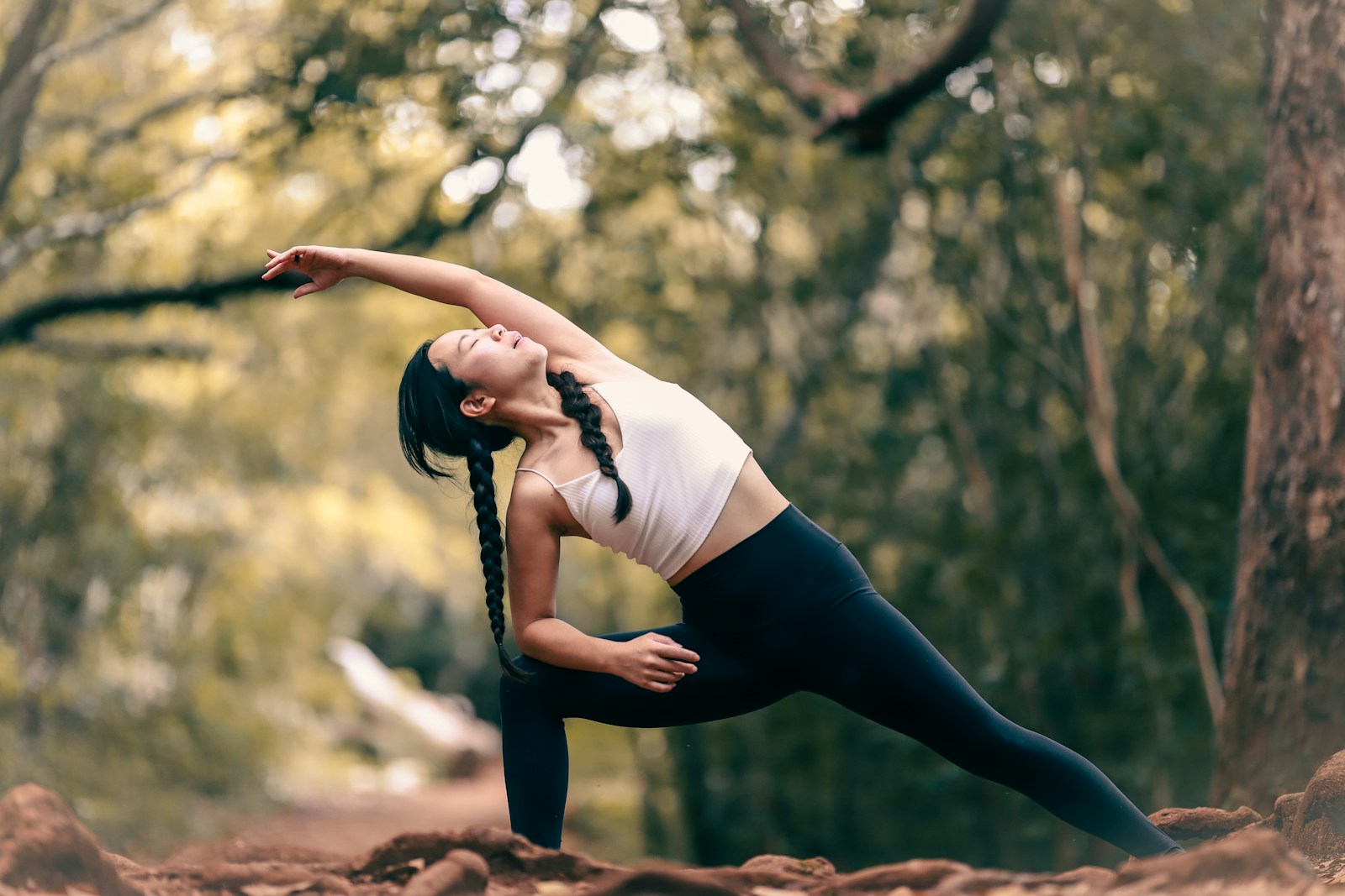 woman in white tank top practicing outdoor yoga